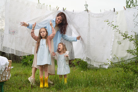 Family ties are strengthened through the innocence of play and the diligence of chores, set in a tranquil rural atmosphere.の写真素材