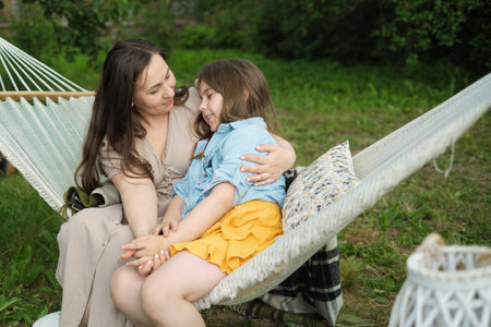mother and daughter deeply connect in quiet afternoon talks, their blissful expressions highlighting the sanctity of familyの写真素材