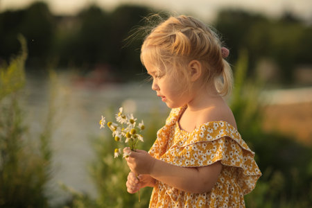 heartfelt smile of girl holding daisies, set against simple park background, advocates for a return to simpler, less materialistic values. benefits of a minimalist lifestyle or simple living.の写真素材