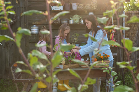 Cultivating Connections: Amidst foliage, mother-daughter duo engage in gardening, growing love and learningの写真素材
