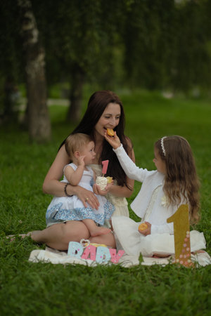A mothers loving gaze towards her children, amidst the tranquility of nature, speaks volumes of the comfort and security that only a parents embrace can provide.の写真素材
