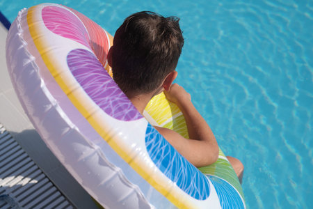 Little swimmer takes a break, safety in pools highlighted. Ties to campaigns on preventing waterborne illnesses and hygiene.の写真素材