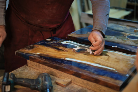 Man at workbench; care, skill. The scene connects to the maker movement, celebrating manual skills and creativity.の写真素材