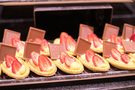 Tartlets topped with figs entice the eye; a sweet treat in a healthy guise. Figs symbolize a turn to natural, nutritious ingredients.の写真素材