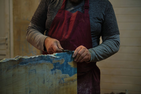 Close-up on hands measuring wood; precision and focus. Represents the meticulous nature of handcrafted goods.の写真素材