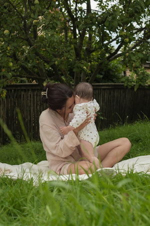 A serene maternal moment outdoors, a woman and her baby connect naturally. Itâs a snapshot of lifes purest relationships.の写真素材
