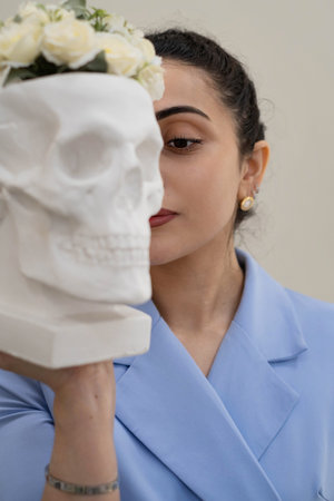 Aesthetician with a flower-topped skull, a striking visual that explores themes of vanity,...
