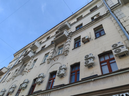 large yellow building with multiple windows and an arched doorway, showcasing classical architectural design. The structure reflects the enduring appeal of historical elegance in urban environments.の写真素材