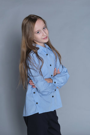 Casual yet elegant young girl in contemporary clothes. Emphasizes the importance of age-appropriate fashion.の写真素材