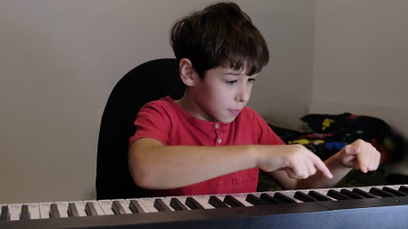 A child in a casual setting develops his musical skills, creating an inspiring atmosphere of learning and passion for music.の写真素材