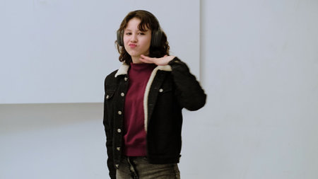 A relaxed child with headphones dances joyfully in a modern setting. This image emphasizes carefree living and the universal connection between music and emotional expression.の写真素材