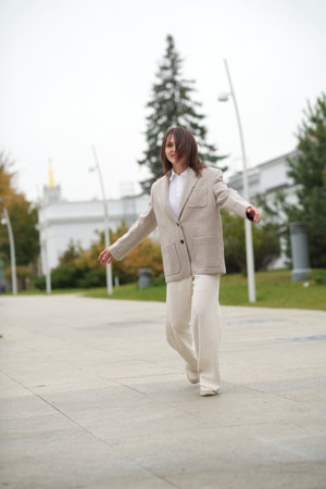 She turns lightly in motion, flashing the inside of her jacket with charm. This moment promotes confidence, natural beauty, and breaking free from societys age-related expectations.の写真素材