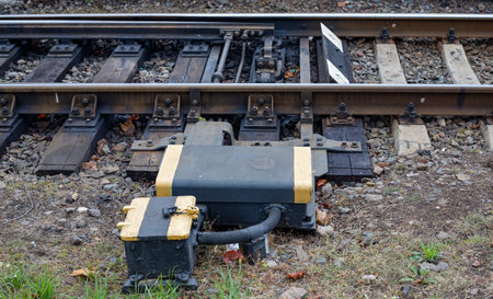 Railway turnout mechanism for switching tracks to change the direction of train travel. Details of a railroad switch showing the mechanical switching components, rail fasteners, and sleepers.の写真素材