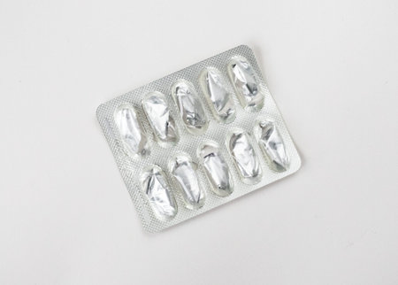 Empty foil blister pack for capsules isolated on white background. Used medications. Healthcare and medicine concept.の写真素材