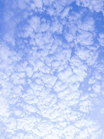 Light clouds float across the blue sky. The sky is illuminated by the sun's rays. Clouds covered the sun.の写真素材