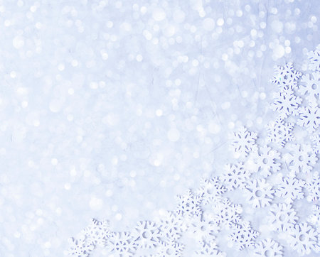 Gentle Christmas, blue background. Layout of artificial snowflakes on a flat surface. Gift packaging on the theme of winter. Bokeh in the form of snow.の写真素材