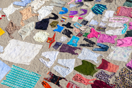 AGRA,INDIA - 25/03/2013 : Laundry service in Yamuna riverside in Agra city ,India.Laundries spread out on the sand of riverside to dry.Unidentified laundrywoman collecting laundries after they dry.のeditorial素材