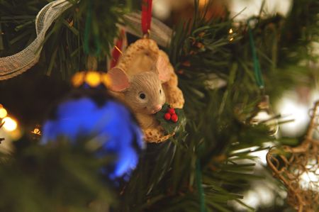 Mouse-in-a-stocking Christmas ornament on the tree.の写真素材