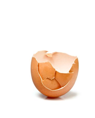 Broken egg with some cracks and missing a part in white background .の写真素材