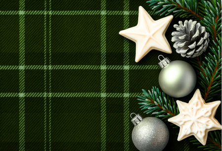 Christmas background with fir branches and decorations on green tartan plaidの素材