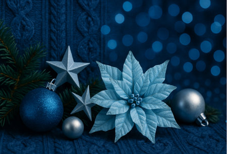 Christmas decoration with poinsettia on a blue knitted backgroundの素材