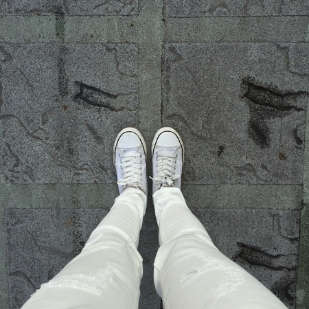 White Sneakers shoes walking on groundの素材