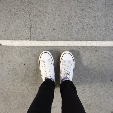 White Sneakers shoes walking on groundの素材