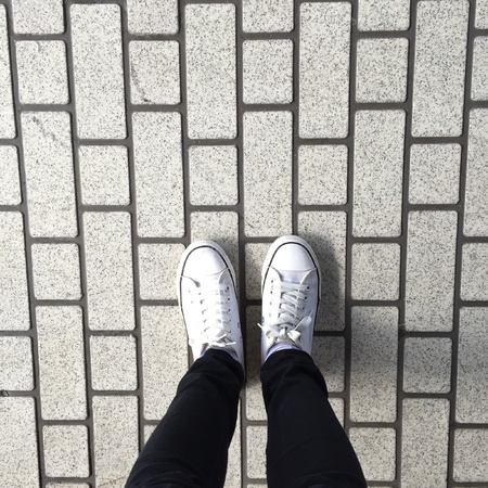 White Sneakers shoes walking on groundの素材
