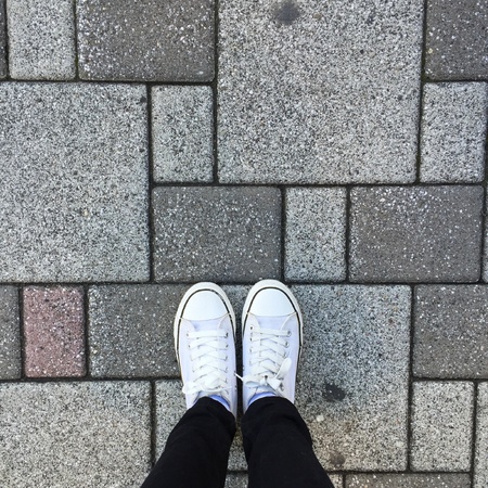 White Sneakers shoes walking on groundの素材