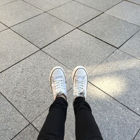 White Sneakers shoes walking on groundの素材
