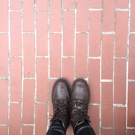 Legs and shoes. Conceptual image of legs in boots. Feet shoes walking in natureの素材