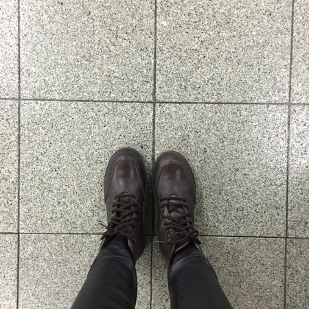 Legs and shoes. Conceptual image of legs in boots. Feet shoes walking in natureの素材