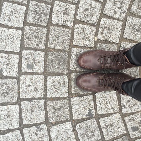 Legs and shoes. Conceptual image of legs in boots. Feet shoes walking in natureの素材