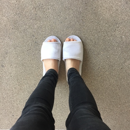 Close up of a woman's white Fluffy slippersの素材
