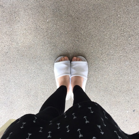 Close up of a woman's white Fluffy slippersの素材