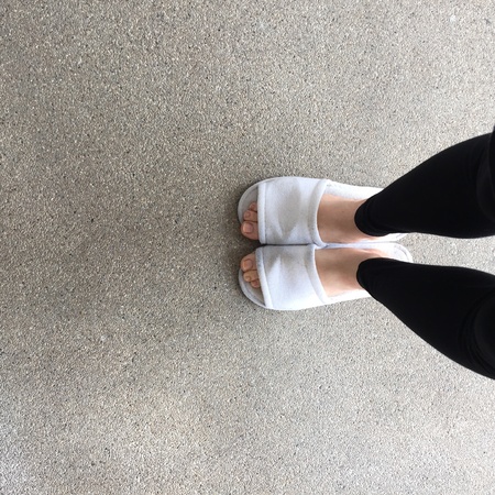 Close up of a woman's white Fluffy slippersの素材