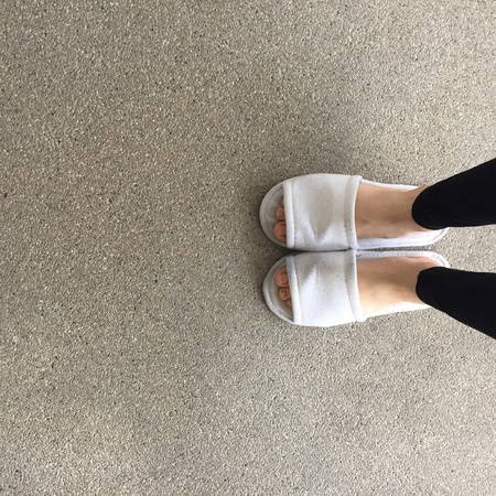 Close up of a woman's white Fluffy slippersの素材