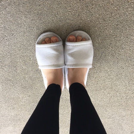 Close up of a woman's white Fluffy slippersの素材