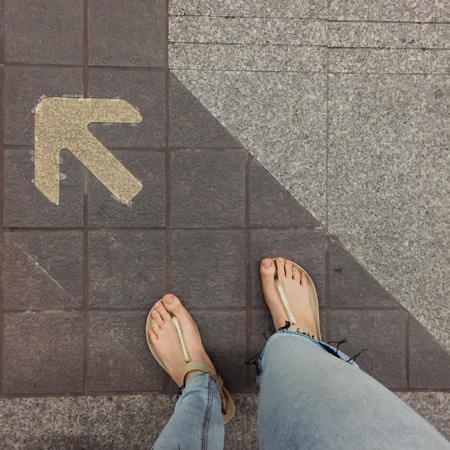 Woman wearing flip flops or slippers standing on background great for any use.の写真素材