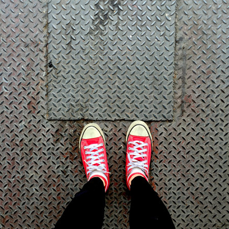 Selfie of Red Sneakers on Girl Legs On Floor Great For Any Use.