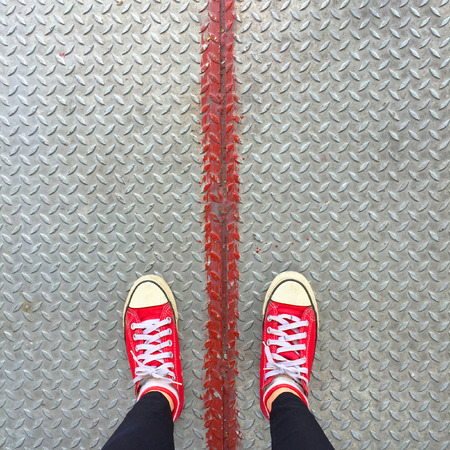 Selfie of Red Sneakers on Girl Legs On Floor Great For Any Use.の写真素材