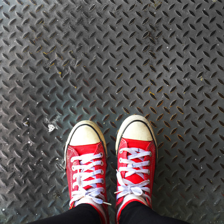 Selfie of Red Sneakers on Girl Legs On Floor Great For Any Useの写真素材