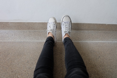 Gumshoes on Urban Grunge Background. Conceptual Image of Legs in Boots on City. Feet Shoes Walking in Outdoor. Youth Selphie Modern Hipster Great For Any Use.の写真素材