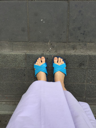 Close up of a Woman's Blue Slippers Buddhist Walking on Street or Ground for Relaxation and...