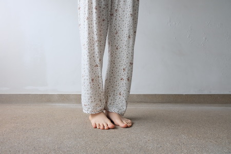 Young Woman's Feet with Plant On Floor or Ground Background Great For Any Use.の写真素材