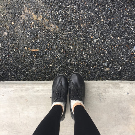 Selfie Feet Wearing Black Shoe for Woman on Floor Background Great For Any Use.