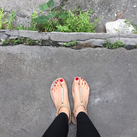Female Legs Wearing Footwear Shoes on Floor Background Great For Any Use.の写真素材