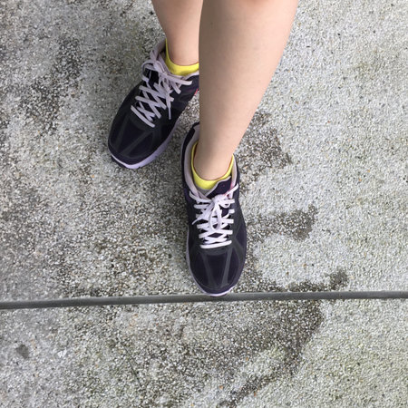 Running Shoes. Barefoot running Shoes Closeup. Woman Wearing Sport Shoes On Tile Background Great...