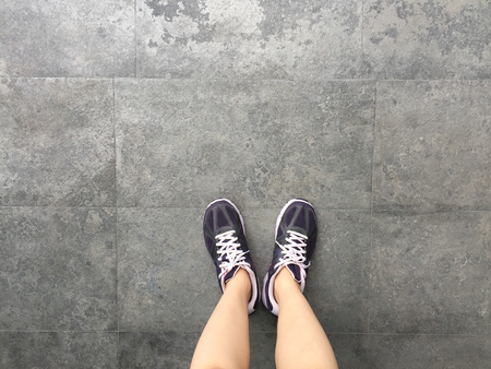 Running Shoes. Barefoot running Shoes Closeup. Woman Wearing Sport Shoes On Ground Or Floor Background Great For Any Use.の写真素材