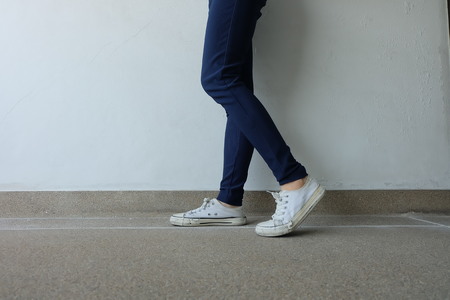 Fashion Young Woman in Blue Jeans and White Sneakers on the Streets Great for Any Use.の写真素材